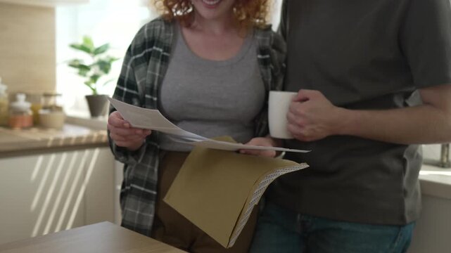 Happy couple reading good news kissing