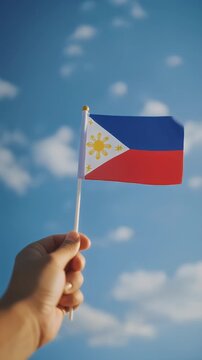 Philippines flag in hand flutters in the wind against the sky, independence national day of Philippines, country freedom, patriotism, Public Holiday, patriotic festival 