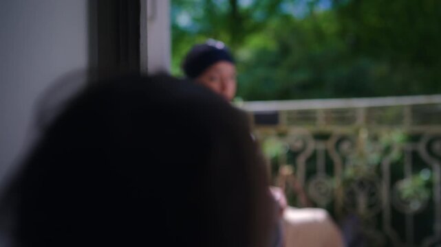 Toddler interacts with mother on balcony then steps inside and closes door, playful routine exploring boundaries and independence in everyday family life at home