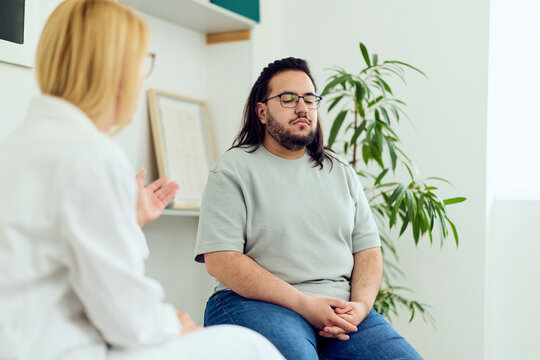 Patient Consultation In Clinic With Calm Patient And Female Clinician During Mental Health Session