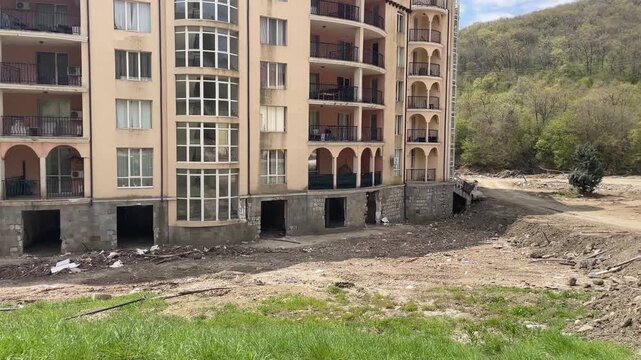 Severe mud and debris flood damage at apartment building in Elenite