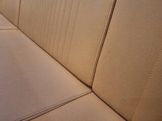 Fototapeta premium Close-up texture of beige tufted leather car seat
