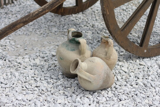 Ancient clay jugs lie on the ground