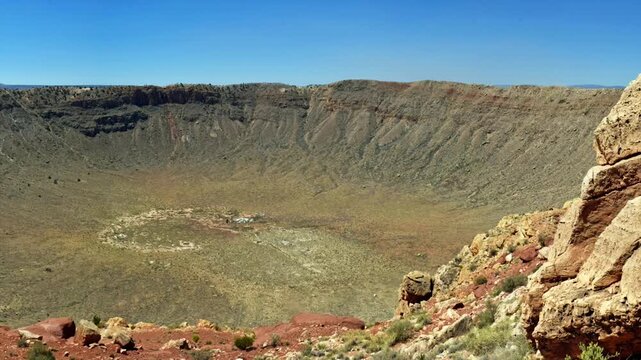 Meteor Crater, or Barringer Crater, is an impact crater about 37 mi east of Flagstaff and 18 mi west of Winslow in the desert of northern Arizona, United States