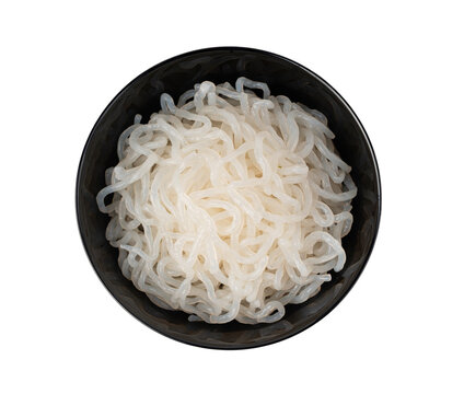 Shirataki or konnyaku pasta in black bowl isolated. Konjak jelly noodles, Japanese zero calorie sirataki