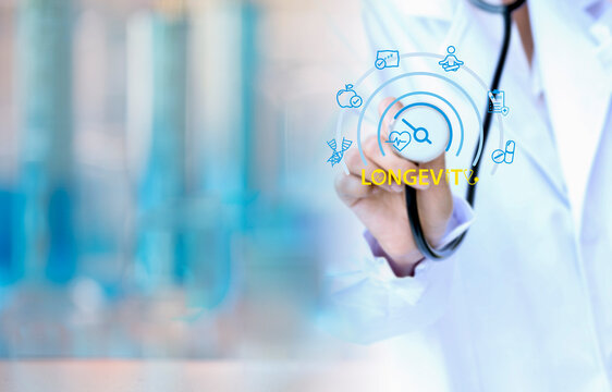 Doctor holding a digital longevity interface with icons related to health and aging, symbolizing advanced medical technology, and anti-aging innovation in a modern clinical environment.