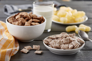 Chocolate and strawberry cereal in white bowls with milk © EdienuFoto
