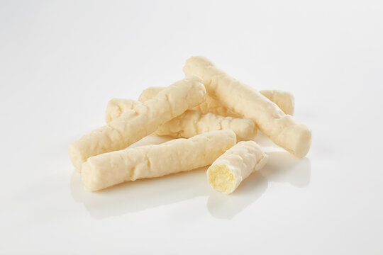 White chocolate covered crispy biscuit sticks on white