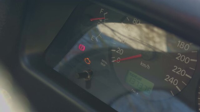 Sun glare distortion. Morning drive reflection effect. Speedometer glare creates artistic visual distortion. Reflected sunlight alters speedometer view with cinematic slow motion