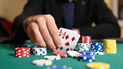 Naklejka premium Player at Poker Table Holding Winning Hand with Ace Cards