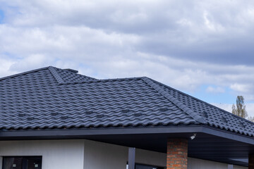 Fototapeta premium Roof Installation in a Residential Area on a Cloudy Day With a Modern Design and Unique Tiles