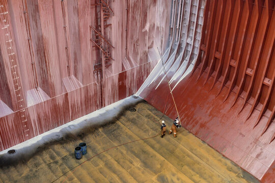 applying of chemical protection coating to the interior surfaces of a cargo hold to prevent contamination between different bulk cargos