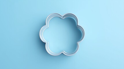 Fototapeta premium Metal flower shaped cookie cutter isolated on a light blue background.
