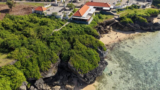 Aerial View of Geger Beach Cliff with Balinese Temple and Clear Turquoise Water