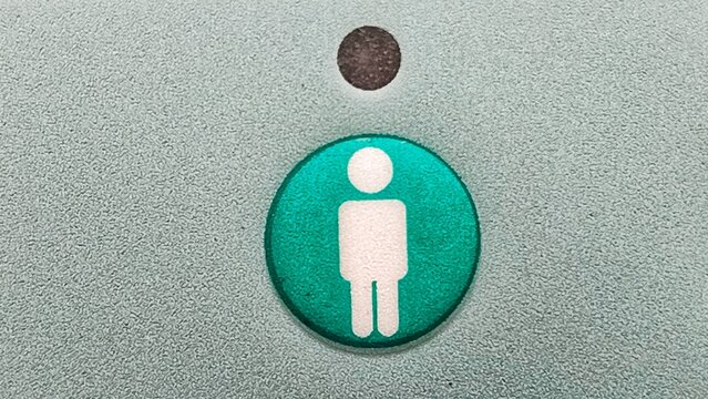 A circular graphic symbol representing a male figure, often used for identification or directional purposes in public spaces