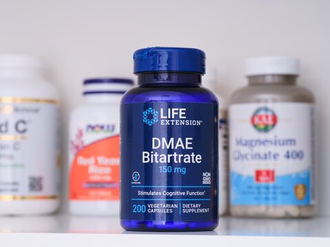 Tambov, Russian Federation - February 19, 2022 A blue bottle of Life Extension DMAE Bitartrate capsules standing on a shelf with other supplement jars. Close-up
