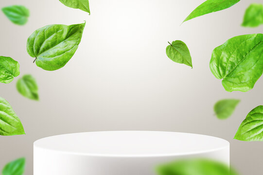 Green betel leaves floating around a clean white podium. Minimal natural mockup background for cosmetic or organic product branding.