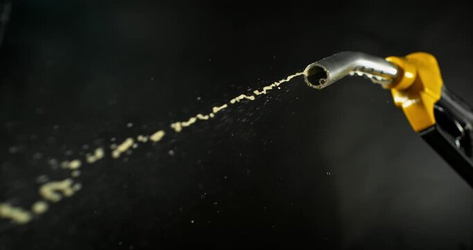 Super slow motion (1000 fps) fuel vapors escaping from gasoline nozzle, symbol of evaporation, depletion and fuel shortage. Minimal emissions on dark background, energy crisis concept.