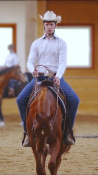 Young western rider focused on riding a pattern in slow motion