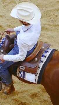 Western rider spin with horse top view slow motion