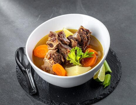 ndonesian Oxtail Soup Sop Buntut with Vegetables and Clear Broth in White Bowl