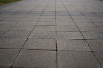 Obraz premium grey paving tile texture, grey tile pattern as background, grey tile texture close up 