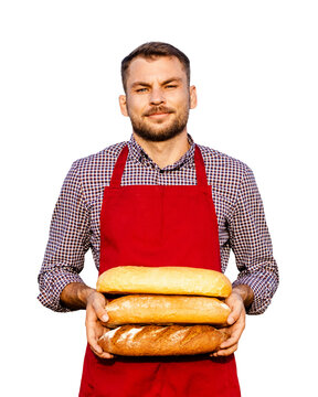 Male baker in red apron holding fresh baked breads.