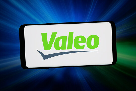 Stuttgart, Germany - 04-13-2026: In this photo illustration, the logo of French automotive company Valeo S.A. is displayed on a smartphone in front of abstract background on computer screen.