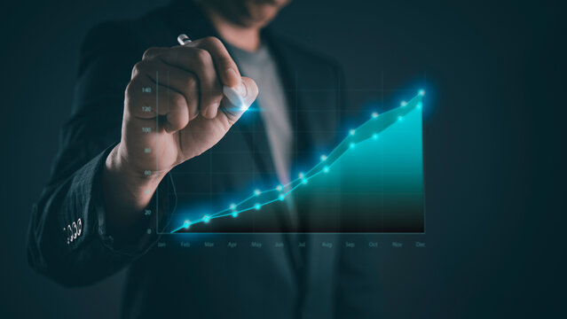 Businessman draws rising financial graph on digital interface, illustrating revenue growth, business analytics, KPI improvement, market performance, forecasting strategy, investment success.