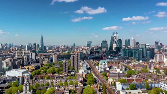 Aerial hyper time lapse view of the skyline of London, England, during a beautiful spring day with sunshine and light clouds