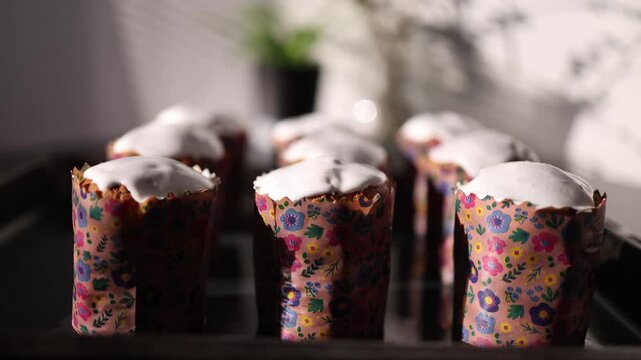 Rows of glazed easter cakes arranged symmetrically on table neat bakery presentation of traditional festive dessert