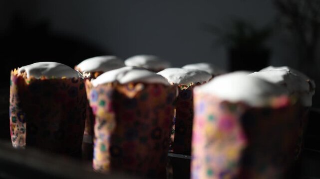 Neatly aligned rows of traditional easter cakes with glossy icing tops creating symmetrical food pattern and bakery presentation