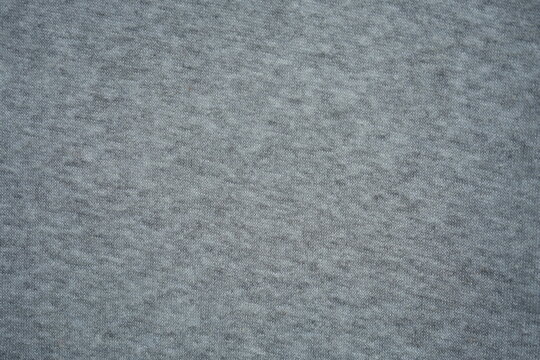 grey fleece fabric texture, macro texture fleece gray fabric photo above as background macro texture of grey fleece fabric. Close-up of soft synthetic textile surface with fine fibers and smooth fluf

