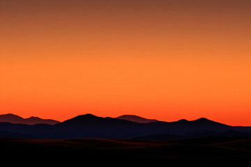 Obraz premium dramatic mountain silhouette against a vibrant orange sunset sky