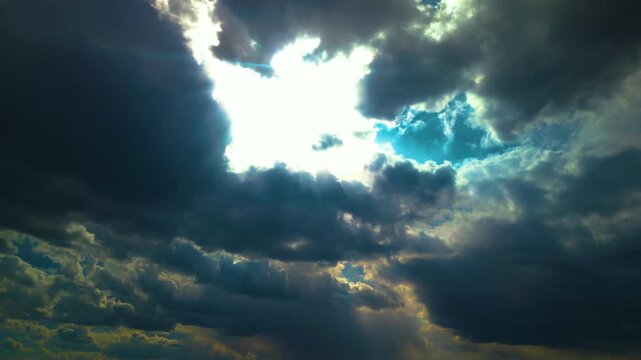 Sun Rays Peeking Through Dark Dramatic Clouds
