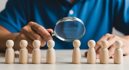 Fototapeta premium Strategic planning and decision making a person examining wooden figures with a magnifying glass