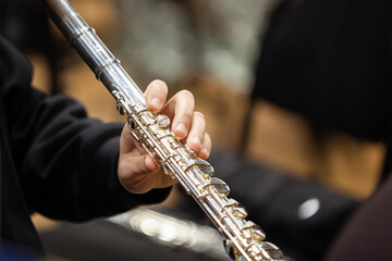 Fototapeta premium Close-up of a musician's hand playing the flute