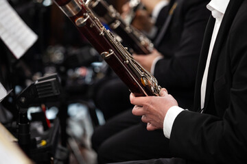 Fototapeta premium Hands of a musician playing the bassoon in an orchestra