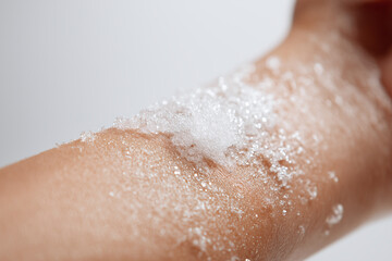 Fototapeta premium Sparkling gel on forearm skin texture closeup soft foam on arm with water droplets and shimmer