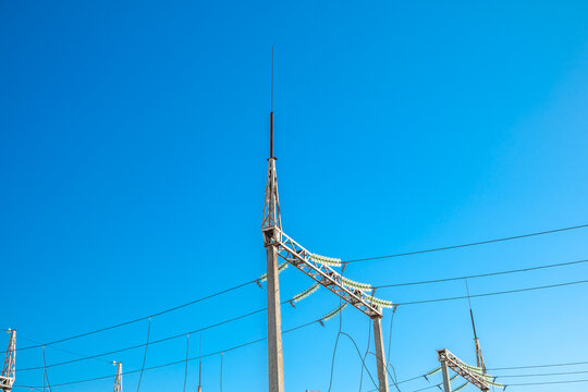 reinforced concrete pillars with electric wires with insulators and lightning rod