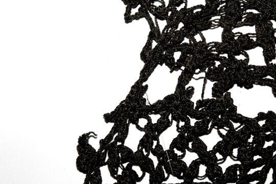 Close up of vintage black gothic lace fabric white on black background embroidery