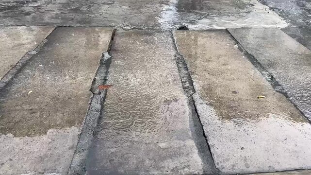 Wet stone slabs show cracks and weathered texture