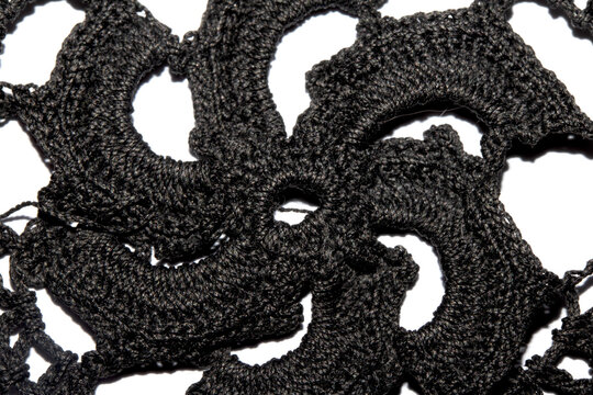 Close up of vintage black gothic lace fabric white on black background embroidery