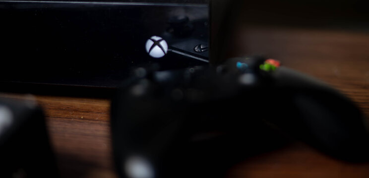 Xbox one console used authentic look, selective focus background image, real authentic playing video games