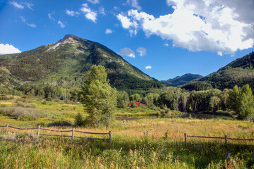 Fototapeta premium Remote mountain meadow ecosystem with freshwater pond