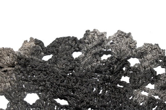 Close up of vintage black gothic lace fabric white on black background embroidery