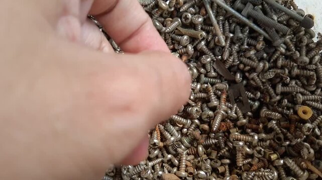 Manufacturing and Industry, Hand Picking Dirty Rustic Screw or Bolt Use for Hold Objects Together and To Position Objects. 