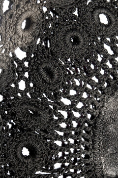 Close up of vintage black gothic lace fabric white on black background embroidery