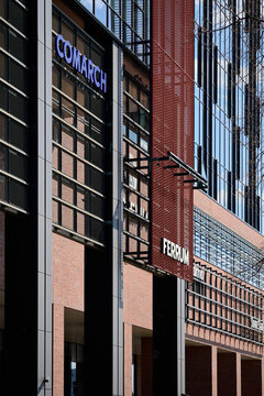 Exterior of the Alchemia Ferrum office building featuring Comarch and State Street corporate signs on a modern steel and brick facade, Gdansk, Poland.