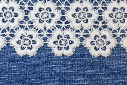 Lace design on denim fabric showing flowers with detailed patterns in afternoon light